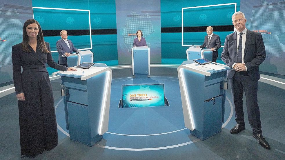 Die Kanzlerkandidaten Armin Laschet (hinten links, CDU), Annalena Baerbock (Bündnis 90/Die Grünen) und Olaf Scholz (SPD) stehen bei der Sendung im Fernseh-Studio in Berlin-Adlershof. Vorne die Moderatoren Pinar Atalay und Peter Kloeppel. Foto: DPA