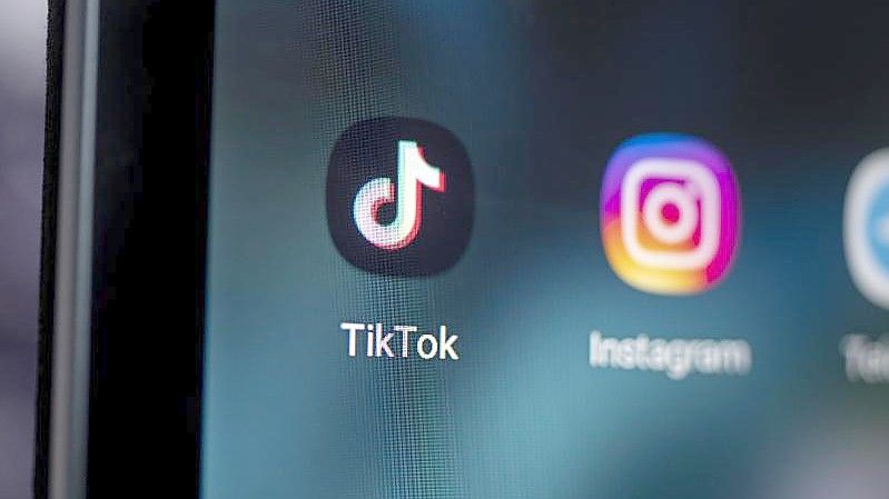 Das Logo der App TikTok (l) auf dem Bildschirm eines Smartphones. Foto: Fabian Sommer/dpa