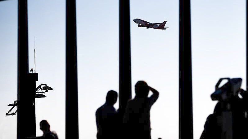 Blick von der Besucherterrasse am Berliner Flughafen auf ein startendes Flugzeug. Foto: Christoph Soeder/dpa