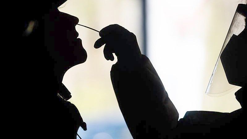 Eine Frau (l) wird in Hannover auf das Coronavirus getestet. Foto: Julian Stratenschulte/dpa