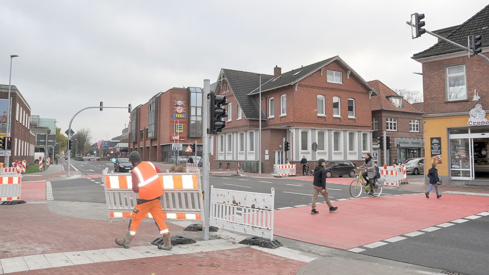Mitarbeiter der Firma Strabag räumen die Absperrungen an den neuen Ampelmasten beiseite. Die Kreuzung Julianenburger Straße/Hafenstraße ist wieder freigegeben. Foto: Kim Hüsing