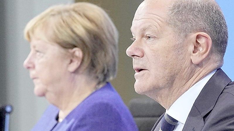 Die geschäftsführende Bundeskanzlerin Angela Merkel und ihr designierter Nachfolger Olaf Scholz bei einer Pressekonferenz im Bundeskanzleramt. Foto: Michael Kappeler/dpa POOL/dpa