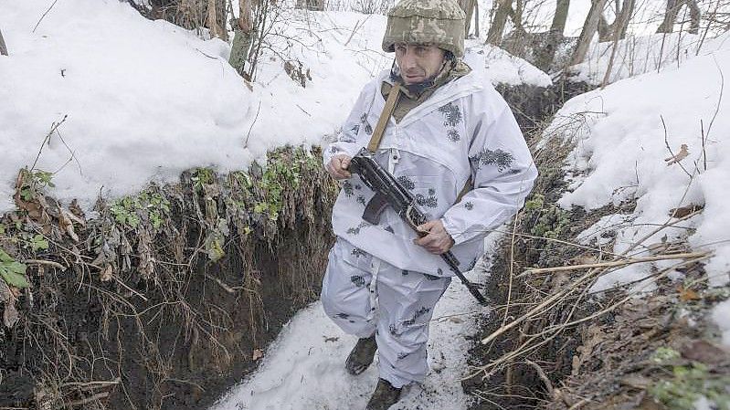 Ein ukrainischer Soldat geht an der Frontlinie zu prorussischen Rebellen in der Region Donezk in einem Schützengraben entlang. Foto: Andriy Dubchak/AP/dpa