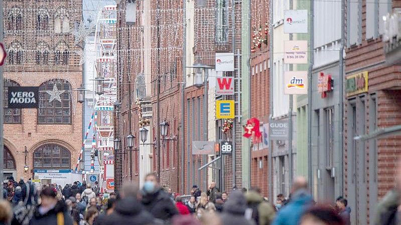 In einer Fußgängerzone sind zahlreiche Passanten unterwegs. Foto: Stefan Sauer/dpa