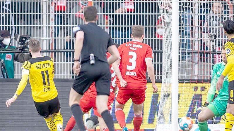 Marco Reus (l) von Borussia Dortmund trifft zum 1:0 gegen Berlins Torwart Andreas Luthe (4.v.r). Foto: Andreas Gora/dpa
