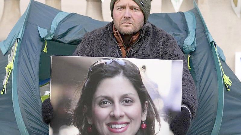 Nazanin Zaghari-Ratcliffes Ehemann Richard Ratcliffe hält bei einem Protest in London im vergangenen November das Foto seiner Frau in den Händen. Foto: Frank Augstein/AP/dpa/Archiv