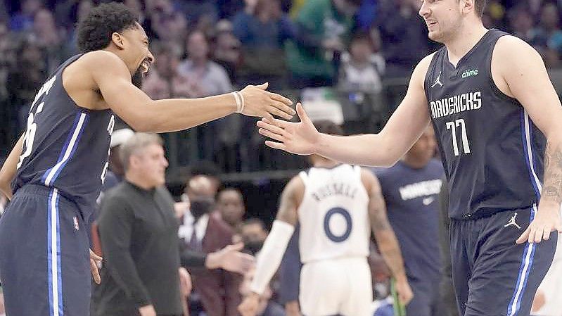 Luka Doncic (77) von Dallas feiert mit Mavericks-Teamkollege Spencer Dinwiddie (26). Foto: Lm Otero/AP/dpa