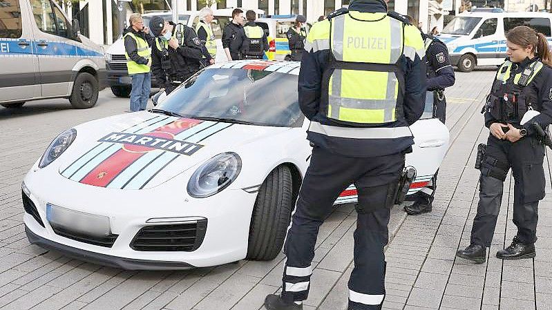 Polizeibeamte kontrollieren einen Porsche am „Car-Freitag“ in Düsseldorf. Foto: David Young/dpa