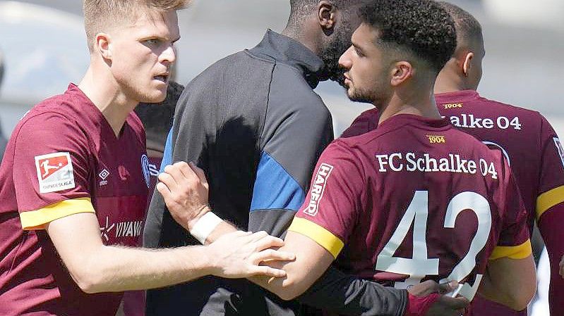 Schalkes Marius Bülter (l) feiert ein weiteres Tor gegen Darmstadt 98 mit Kerim Calhanoglu. Foto: Thomas Frey/dpa