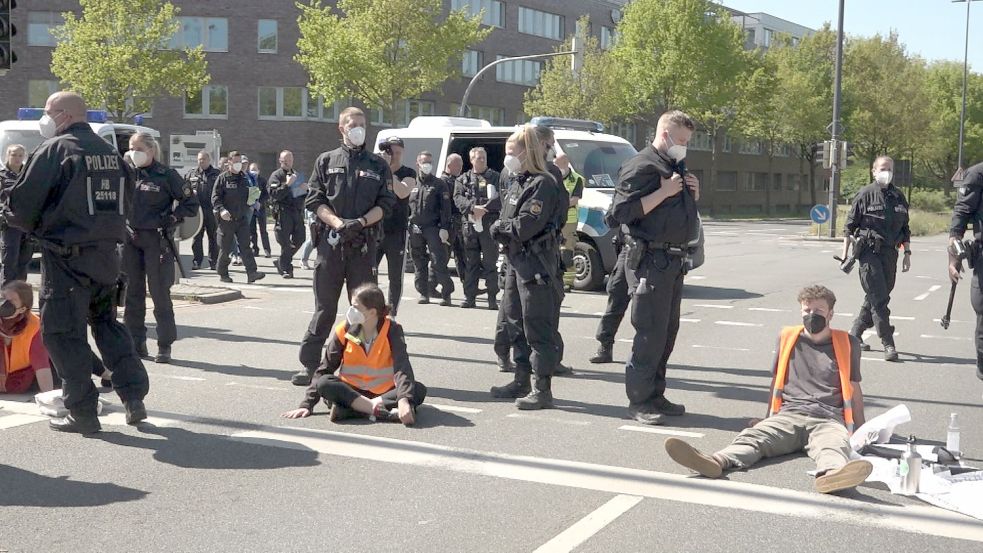 Aktivisten haben sich am Montag in Bremen mit Sekundenkleber auf einer Straße festgeklebt. Foto: Nonstopnews