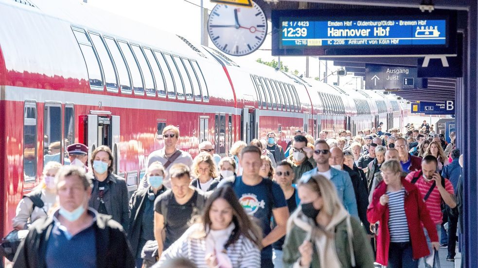 Zahlreiche Reisende kommen am Freitag am Bahnhof Norddeich Mole an. Die Reederei Norden-Frisia setzt angesichts des hohen Anreiseaufkommens zusätzliche Fähren ab Norddeich ein. Foto: DPA