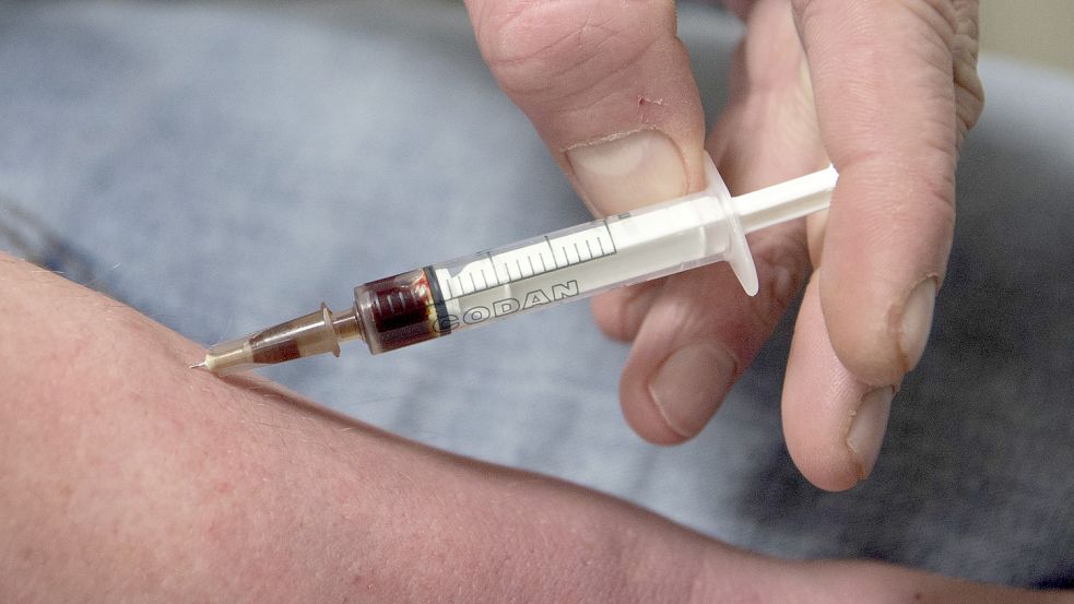 Ein Drogensüchtiger spritzt sich Heroin. Foto: Boris Roessler/DPA