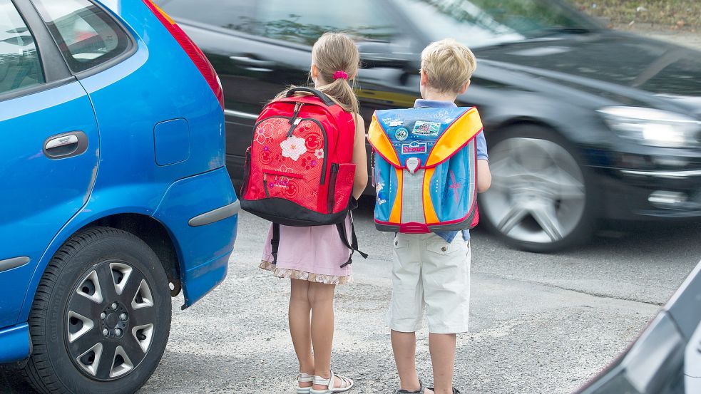 Parkende Autos, fließender Verkehr und mittendrin Schulkinder: Wegen sogenannter Elterntaxis kommt es in Südbrookmerland immer wieder zu problematischen Situationen vor Kitas und Schulen. Foto: Patrick Pleul/DPA