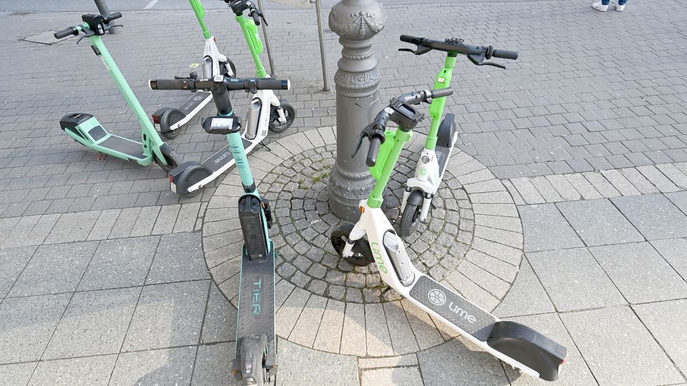 E-Scooter verschiedener Anbieter stehen um einen Lichtmasten herum. Viele nervt ein solcher Anblick. Foto: dpa