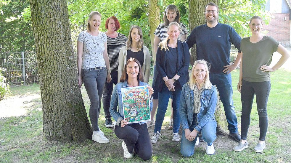 Der Vorstand des Vereins und die Leitung des Kindergartens: Insa Carls ( von links, erste Kassiererin), Hilke Goldenstein (Erzieherin), Alina Meinema (Erzieherin), Stefanie Olthoff (Schriftführerin), Inga Janssen-Rocker (Erzieherin), Thorsten Friedrichs (zweiter Vorsitzender), Anna Goldenstein (zweite Kassiererin). Kniend: Alexandra Kuhlmann (Leiterin des Kindergartens) und Meike Heymann, Vorsitzende. Auf dem Foto fehlt Erzieherin Marion Janssen. Foto: Gerd-Arnold Ubben