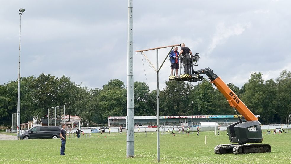 Die Elektriker demontieren die Flutlichtanlage. Am Montag begannen die Erdarbeiten für den neuen Kunstrasenplatz. Foto: Helmut Vortanz