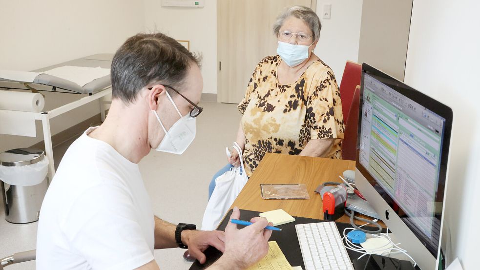 Ein Hausarzt mit einer Patientin. Foto: DPA
