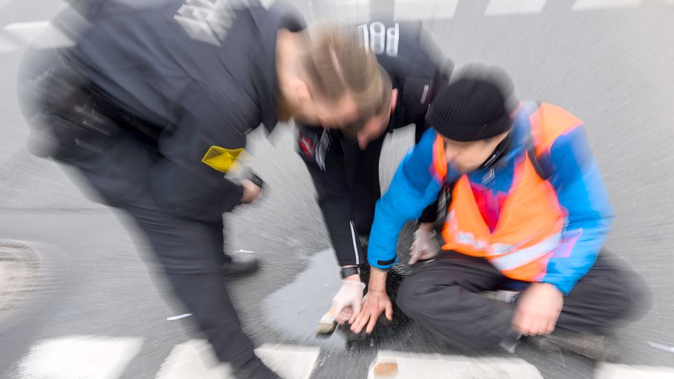 Das Land Niedersachsen sieht keine rechtliche Grundlage dafür, Klimakleber für Polizeieinsätze zur Kasse zu bitten. Foto: Julian Stratenschulte/dpa