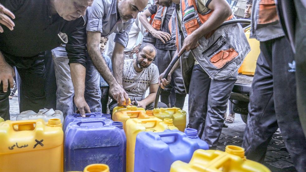 Palästinenser stehen Schlange, um Wasser zu bekommen. Foto: Abed Rahim Khatib/dpa