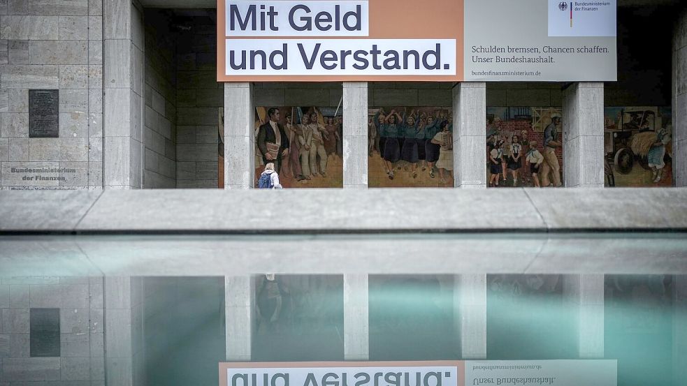 Ein Plakat mit der Aufschrift „Mit Geld und Verstand. Schulden bremsen, Chancen schaffen. Unser Bundeshaushalt.“ hängt über dem Eingang zum Bundesministerium der Finanzen. Foto: Kay Nietfeld/dpa