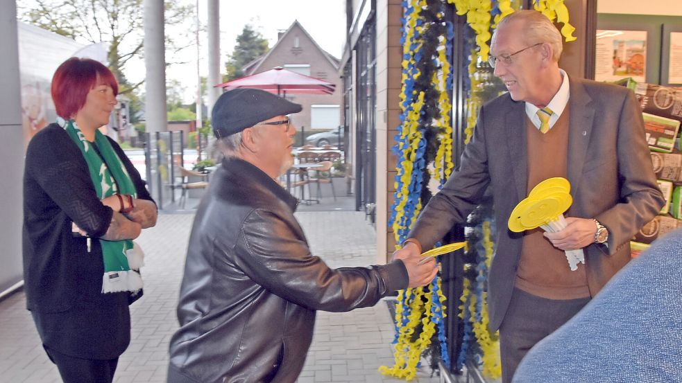 Uwe Jakobs aus Upgant-Schott (links) zählte am frühen Donnerstagmorgen zu den ersten Kunden im neuen E-Center. Der Betreiber Manfred Kruse überreichte ihm eine Fliegenklatsche. Foto: Thomas Dirks