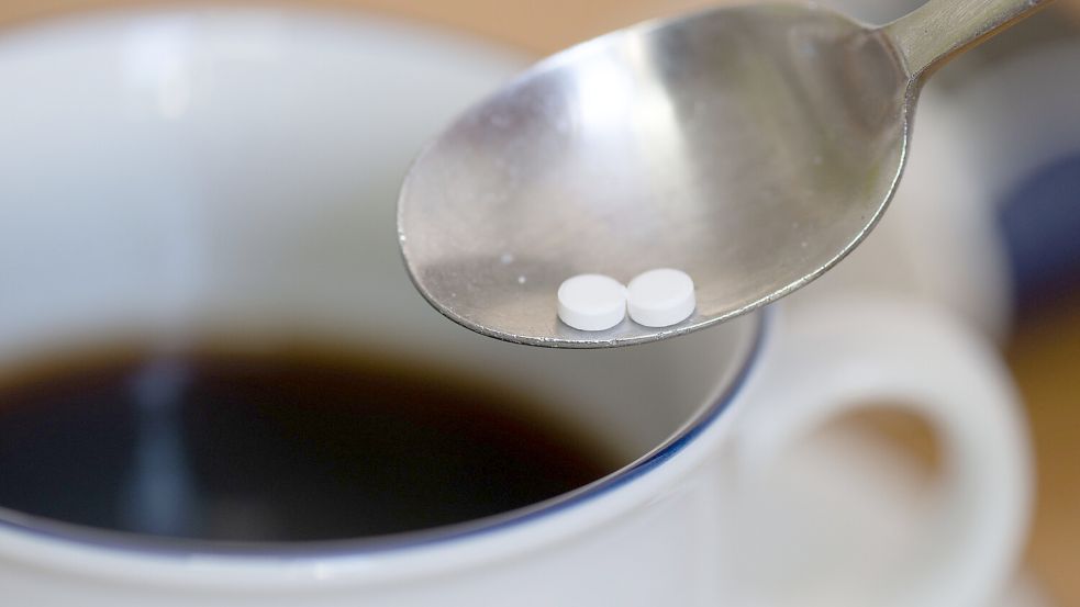 Ein Löffel mit zwei Süßstofftabletten ist über einer Tasse Kaffee zu sehen. Foto: DPA
