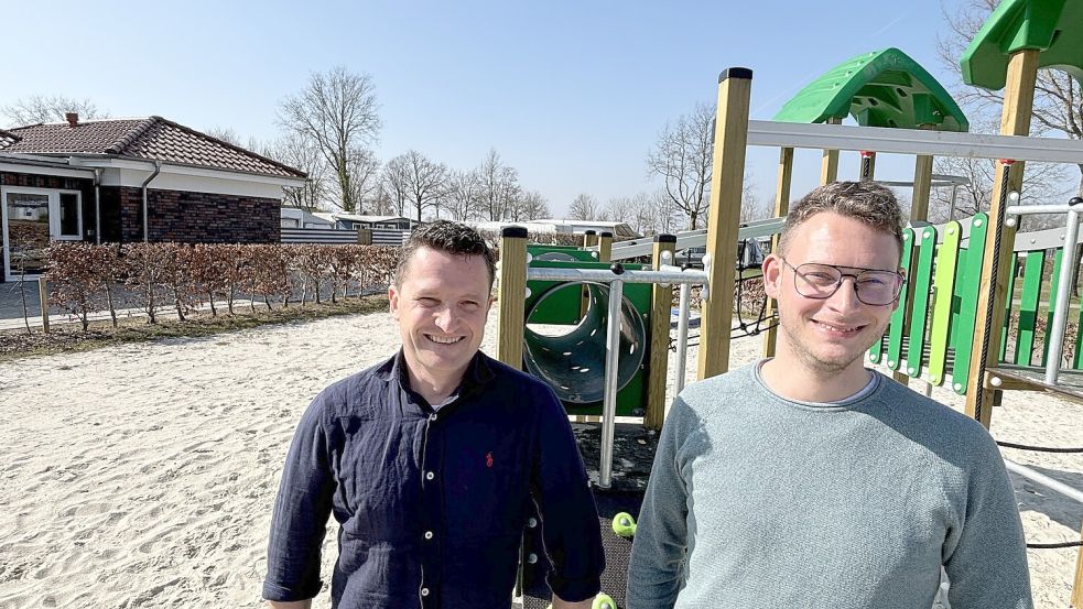 Simon Willms (links) und Christian Albers vor dem neuen Spielgerät auf dem Campingplatz und vor dem kernsanierten Sanitärgebäude. Foto: Karin Böhmer