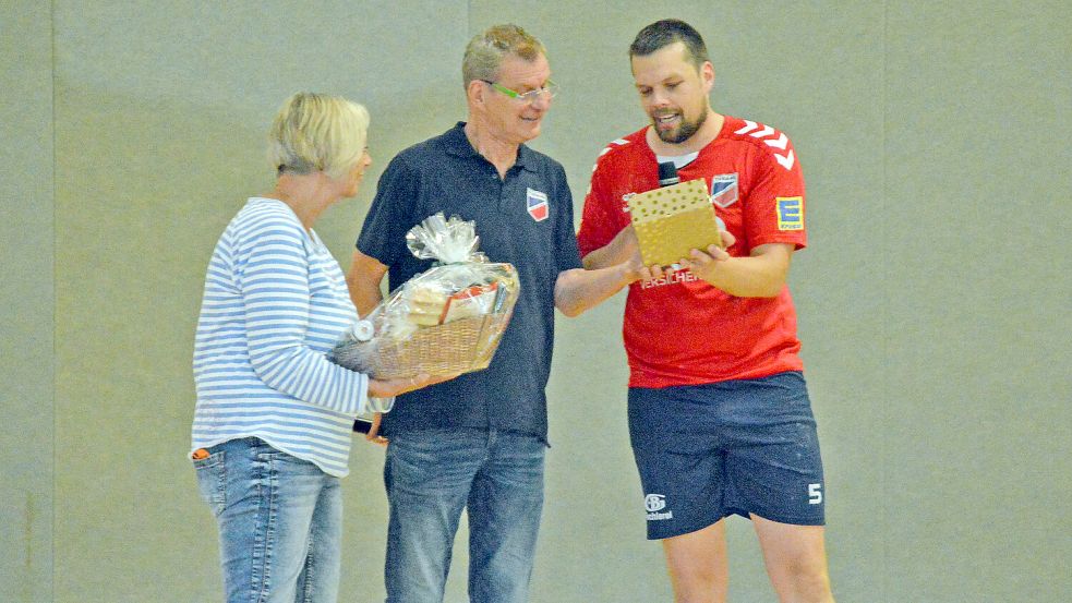 Spartenleiter Tido Poppinga und 2. Vorsitzende Ute Stüben überreichten Hallensprecher Bernhard Schwitters zum Abschied Präsente. Foto: Sarah Dirks