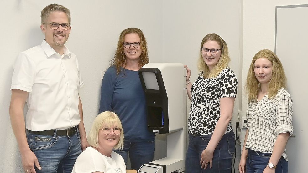 Erster Gemeinderat Frank Cramer (von links) und die Mitarbeiterinnen Heike Hippen, Stefanie Lobinski, Sandra Gronewold und Lena Arend mit dem neuen Fotoautomaten der Gemeinde Großefehn. Foto: Gemeinde Großefehn