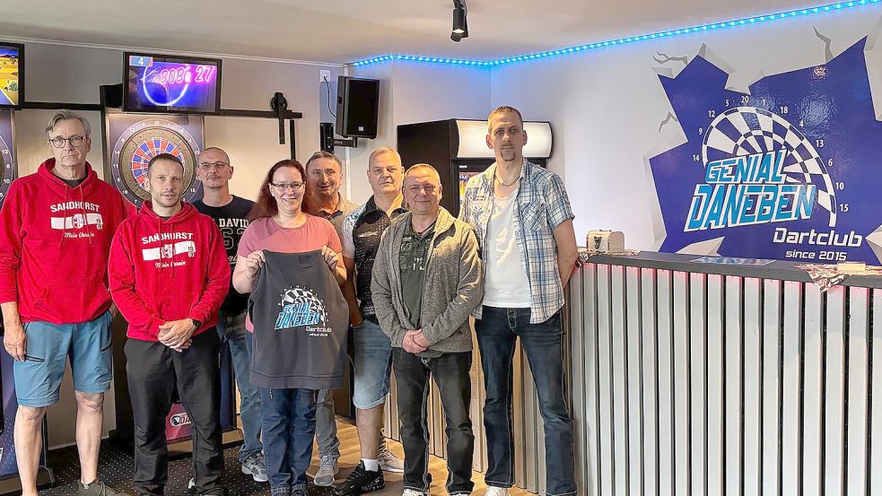 Die Darts-Spieler von „Genial daneben“ werfen nun in Sandhorst ihre Pfeile – sehr zur Freude des TuS-Vorstandes um Jan Willms (links). Foto: Marco Lindenbeck