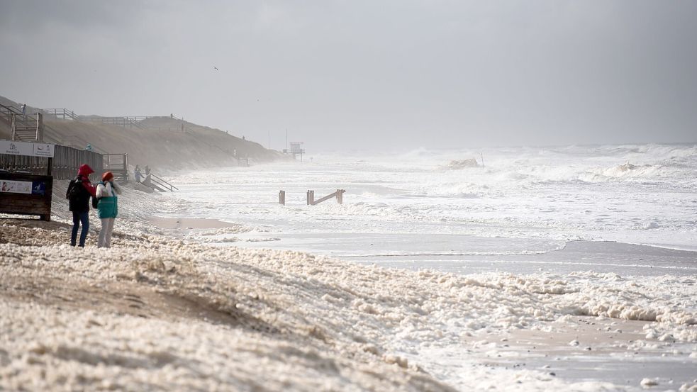 Sturmflut vor Sylt. Das Wetter lockte auch Spaziergänger an die Nordsee. Foto: Daniel Bockwoldt