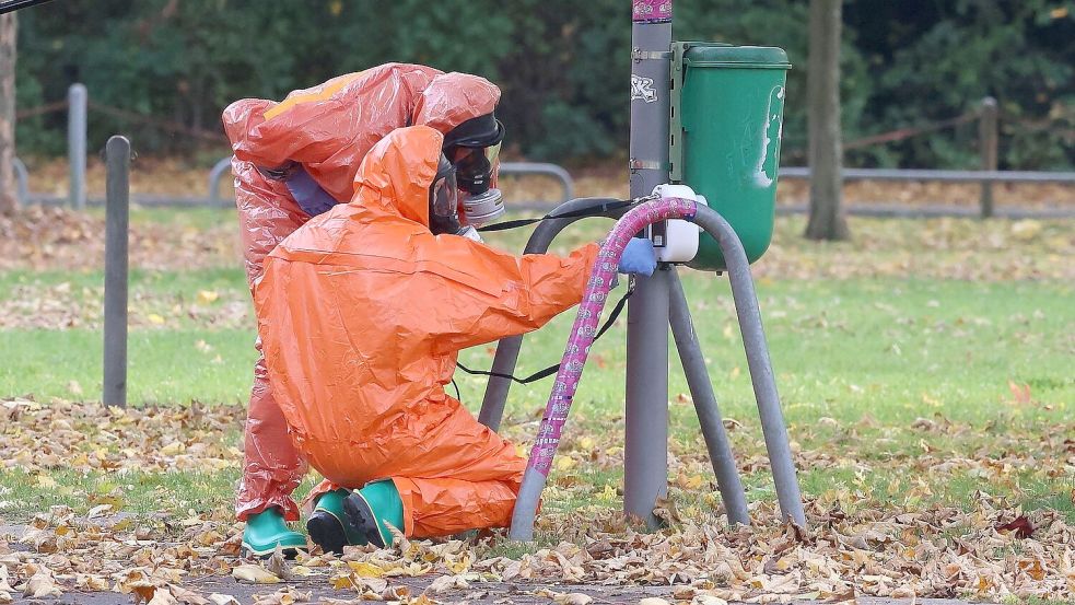 Feuerwehrleute überprüfen eine Mülltonne. Foto: David Young