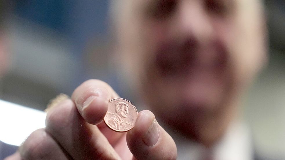 US-Schatzmeister Brandon Beach hält einen der letzten in der US-Münzanstalt in Philadelphia gepressten Pennys in die Kamera. Foto: Matt Slocum/AP/dpa