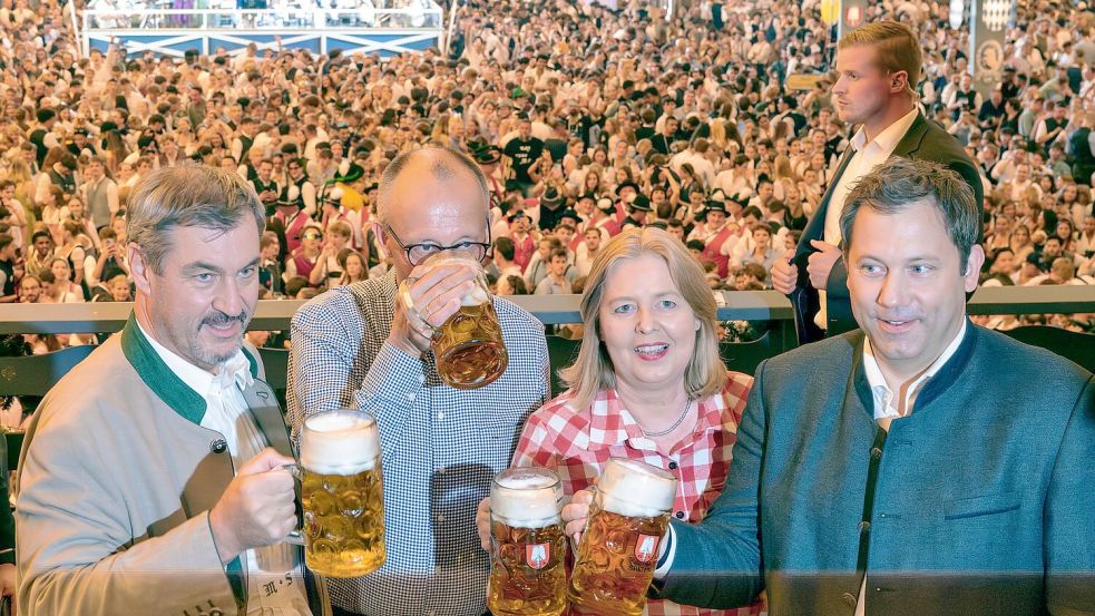 Wenige Tage vor der Veröffentlichung seines Wiesn-Hits „Sweet Caroline“ lotste CSU-Chef Markus Söder (links) Kanzler Friedrich Merz (2.v.l.) und das SPD-Führungsduo Bärbel Bas und Lars Klingbeil auf das Oktoberfest. (Archivbild) Foto: Peter Kneffel/dpa