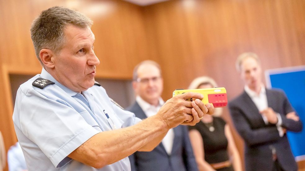 Ein Polizist erklärte die Funktionsweise eines Distanz-Elektroimpulsgeräts im vergangenen Jahr im Innnenministerium. (Archivfoto) Foto: Michael Kappeler/dpa