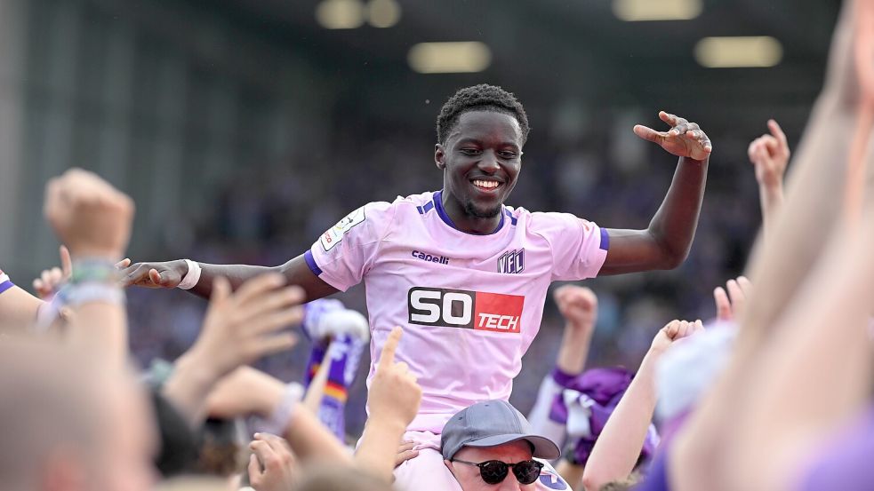 Ismail Badjie feiert auf den Schultern der Fans den Aufstieg in die 2. Bundesliga und die Meisterschaft. Foto: Michael Titgemeyer