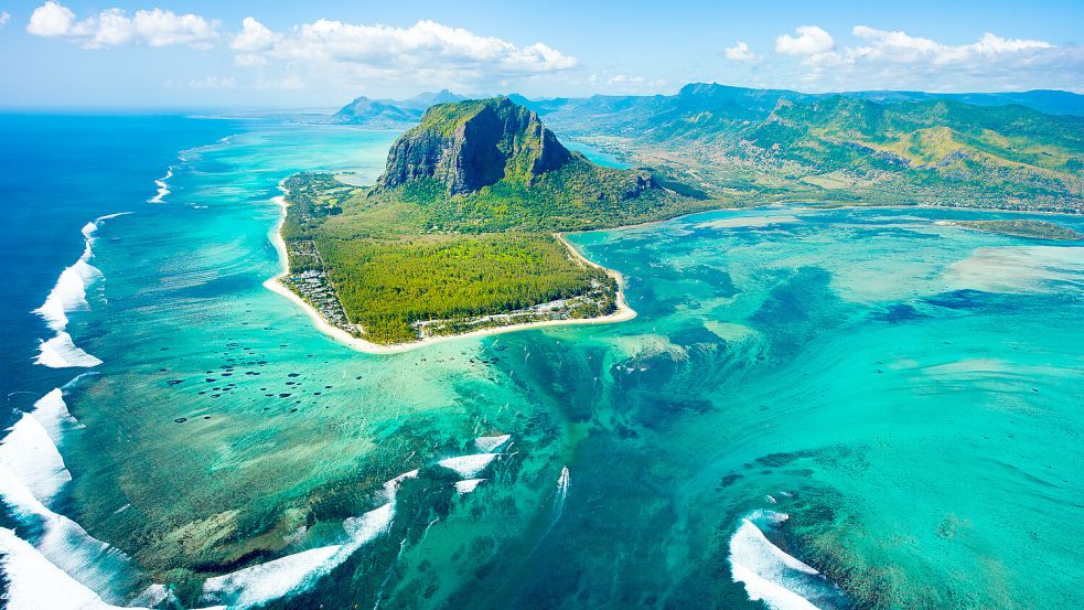 Am besten sieht man die optische Illusion des Unterwasserwasserfalls Le Morne aus der Luft. Im Hintergrund ist der Berg Le Morne Brabant zu sehen, von dem aus man einen guten Blick über die Insel hat. Foto: Istockphoto.com / Myroslava