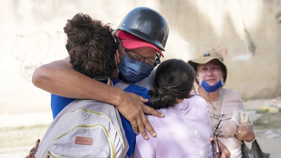 Oscar Perez umarmt seine Familie, nachdem er sie drei Tage nach dem Erdbeben in La Guaira wiedergefunden hat. Foto: Matias Delacroix