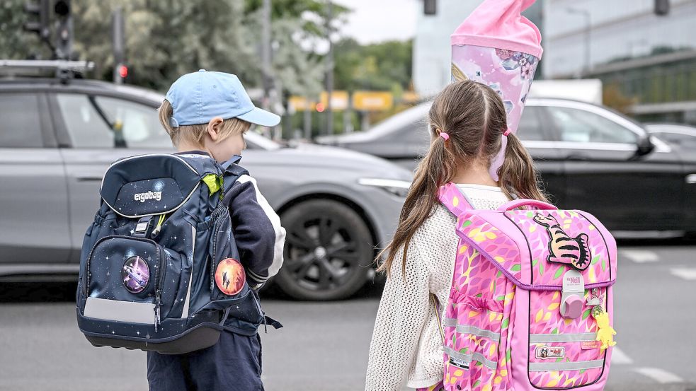 Schulanfänger stehen an einer befahrenen Straße. Foto: DPA / Britta Pedersen