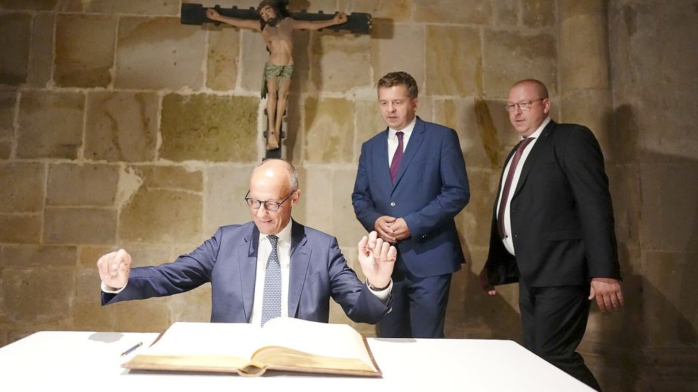 In Quedlinburg trägt Merz sich ins Goldene Buch der Stadt ein. Foto: Kay Nietfeld/dpa-Pool/dpa